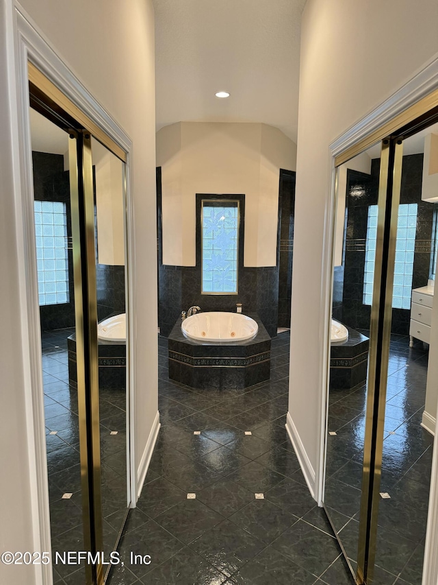 bathroom featuring tiled bath