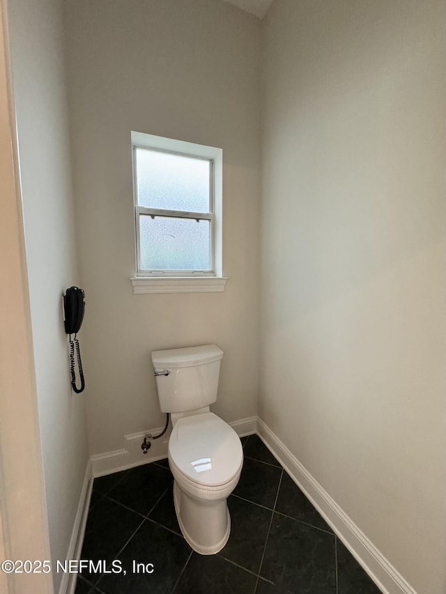 bathroom featuring tile patterned flooring and toilet