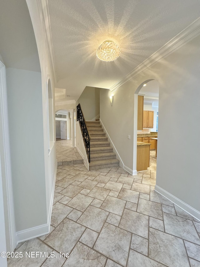 interior space featuring crown molding and a textured ceiling