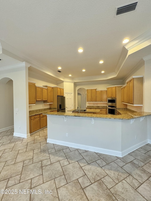 kitchen featuring sink, light stone counters, crown molding, kitchen peninsula, and stainless steel appliances