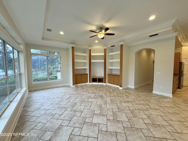 unfurnished living room featuring crown molding, built in features, and ceiling fan