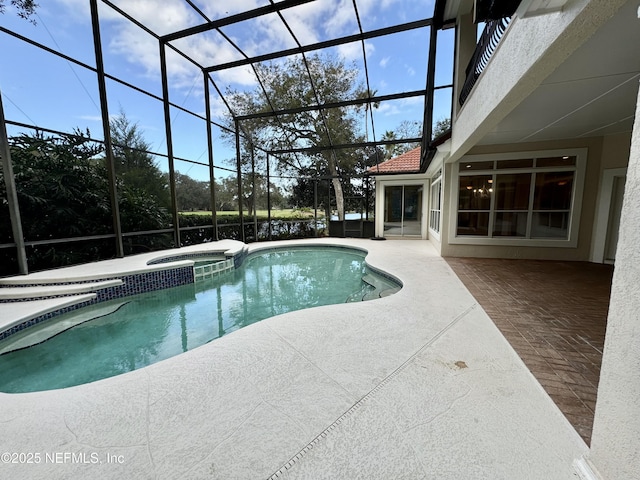 view of pool featuring a patio, a lanai, and an in ground hot tub