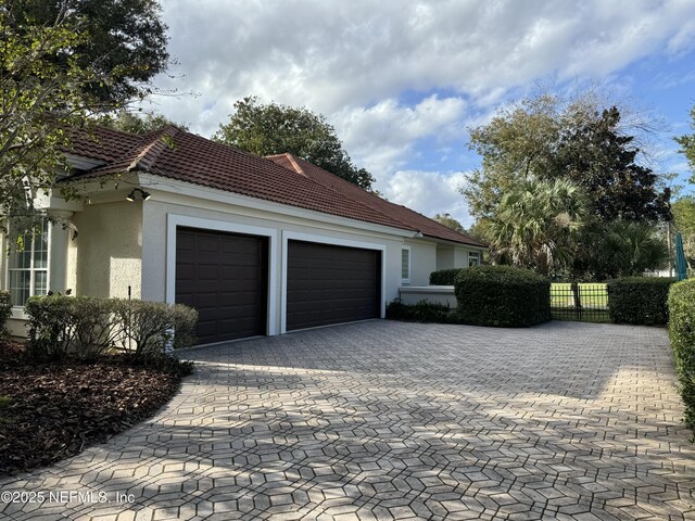 view of side of home featuring a garage