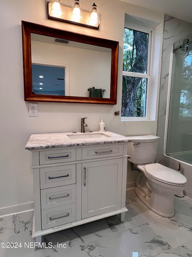 full bathroom featuring bath / shower combo with glass door, vanity, and toilet