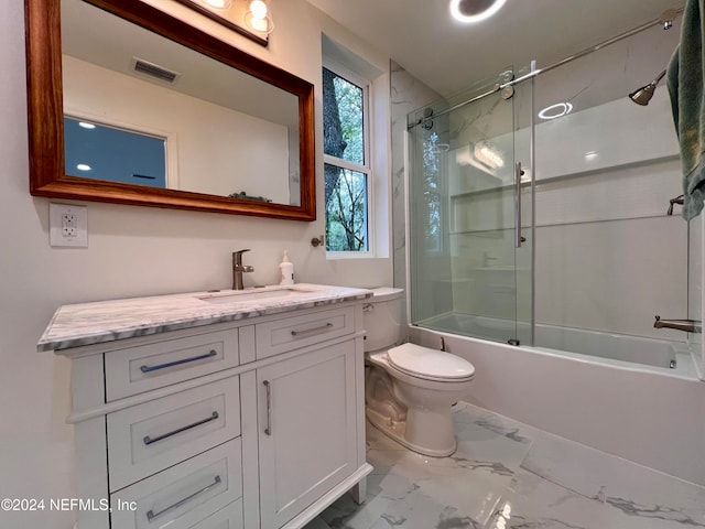 full bathroom with toilet, vanity, and tiled shower / bath