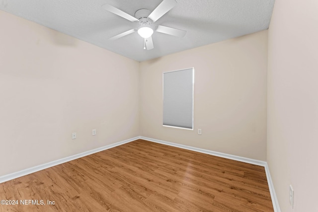 unfurnished room featuring a textured ceiling, wood-type flooring, and ceiling fan