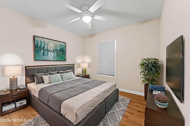 bedroom with hardwood / wood-style floors and ceiling fan