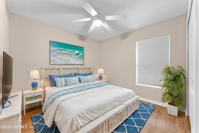 bedroom featuring light hardwood / wood-style floors and ceiling fan