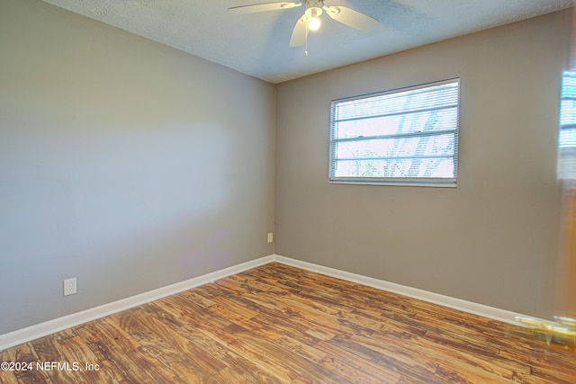 spare room featuring ceiling fan, hardwood / wood-style floors, and a textured ceiling