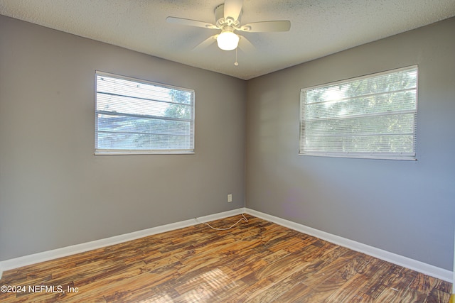 unfurnished room with wood-type flooring, a textured ceiling, and ceiling fan