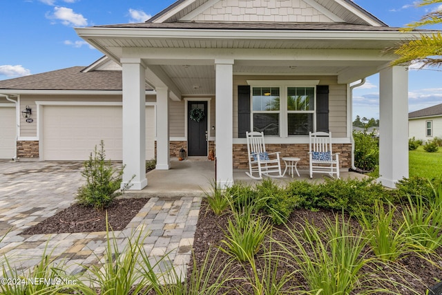 view of front of property featuring a garage and a porch