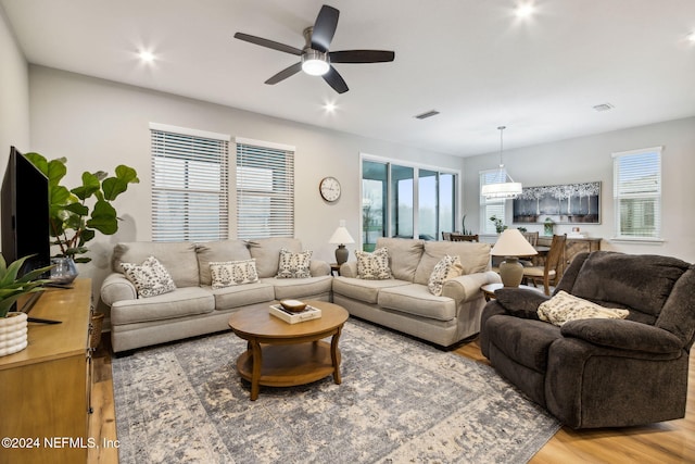 living room with hardwood / wood-style flooring and ceiling fan