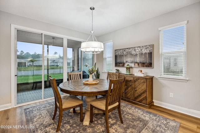 dining room featuring hardwood / wood-style floors and an inviting chandelier