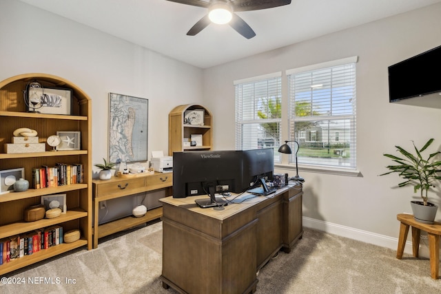 carpeted office space with ceiling fan