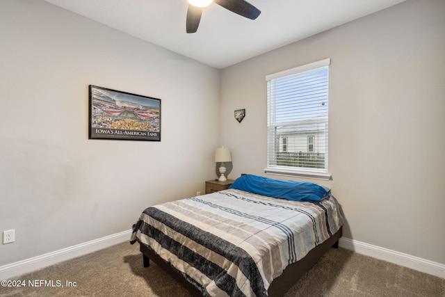 bedroom featuring ceiling fan and dark carpet