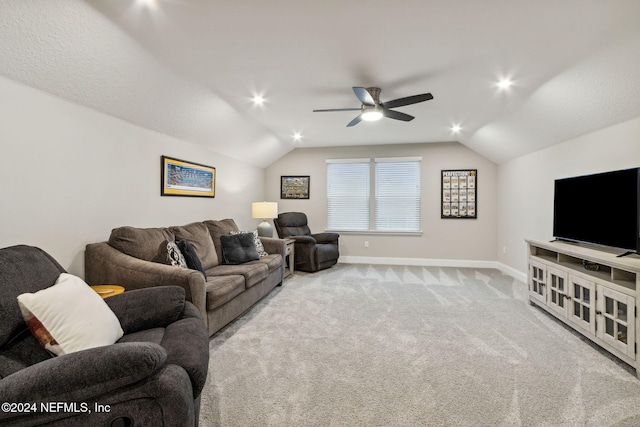 carpeted living room featuring ceiling fan and vaulted ceiling