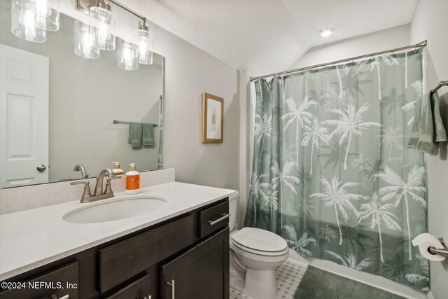 full bathroom with vanity, vaulted ceiling, tile patterned flooring, toilet, and shower / tub combo with curtain