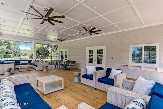 view of patio / terrace with french doors, ceiling fan, an outdoor living space, and a deck