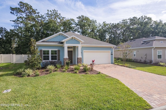 view of front of property with a front lawn and a garage