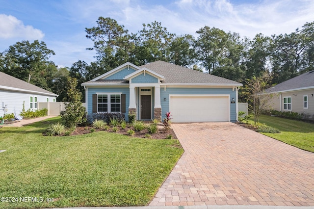 craftsman inspired home with a front yard and a garage