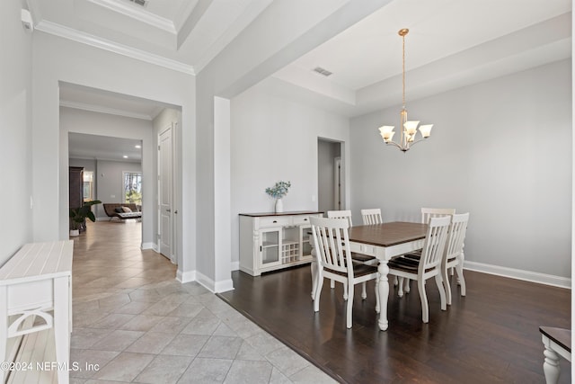 dining area with a chandelier, hardwood / wood-style floors, and ornamental molding