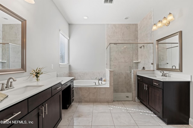 bathroom featuring tile patterned floors, vanity, and independent shower and bath