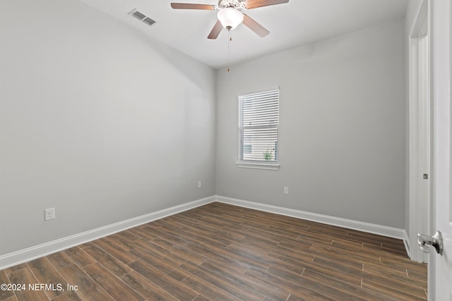 spare room with dark hardwood / wood-style flooring and ceiling fan