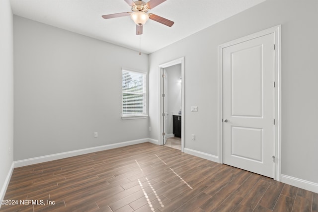 unfurnished bedroom with ceiling fan, dark hardwood / wood-style flooring, and a textured ceiling