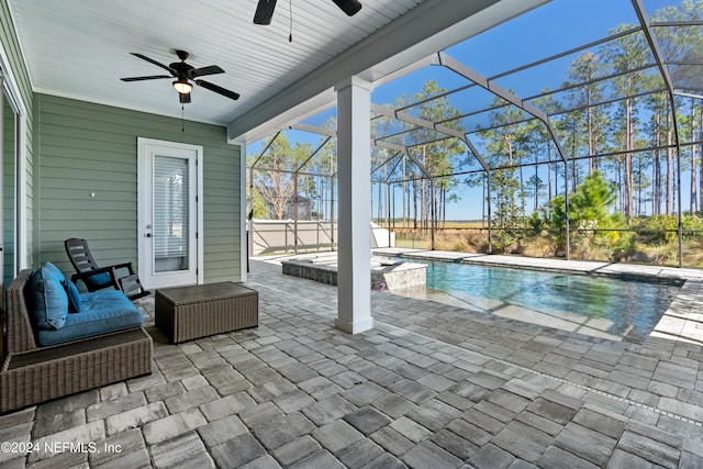 view of pool with a lanai, ceiling fan, and a patio