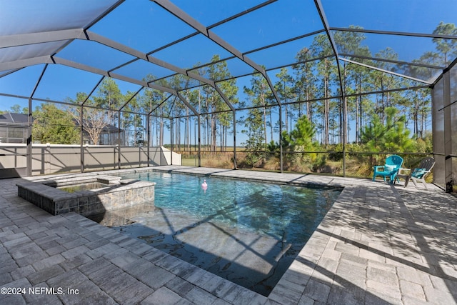 view of swimming pool featuring a lanai, an in ground hot tub, and a patio