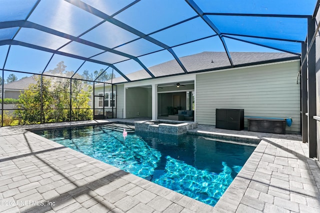 view of pool featuring glass enclosure, ceiling fan, and a patio