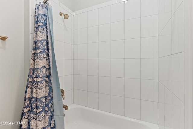 bathroom with shower / bath combination with curtain