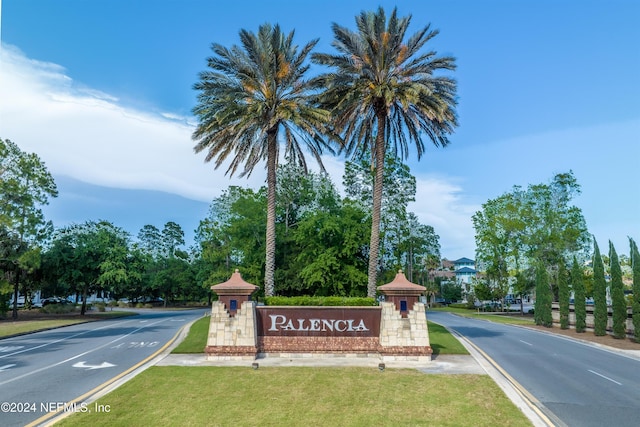 community sign featuring a lawn