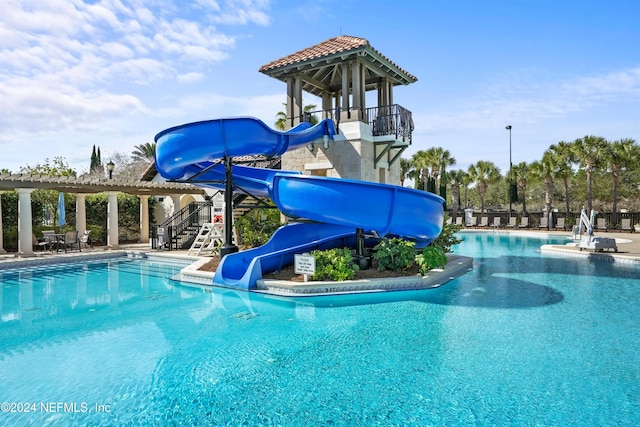 view of swimming pool featuring a water slide