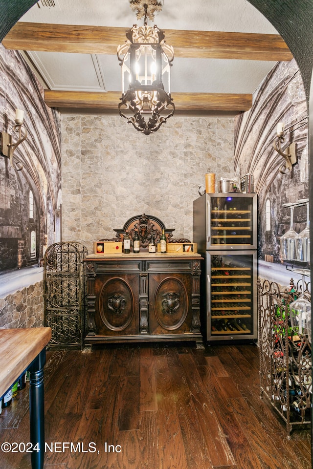 wine room featuring dark hardwood / wood-style floors, beam ceiling, and beverage cooler