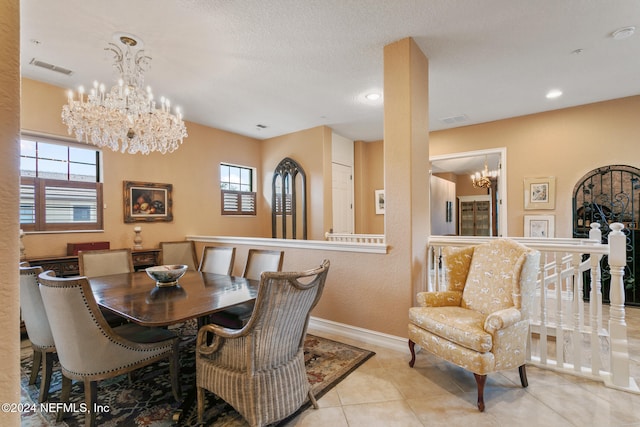 dining room with light tile patterned flooring and a textured ceiling