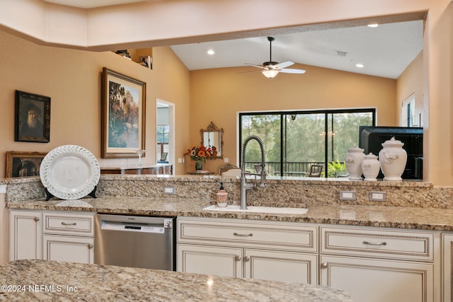 kitchen featuring sink, light stone countertops, ceiling fan, stainless steel dishwasher, and vaulted ceiling