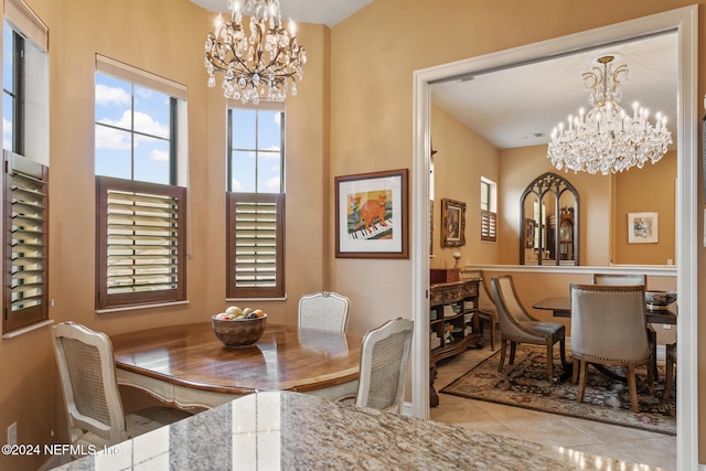 dining room featuring light tile patterned flooring and a chandelier