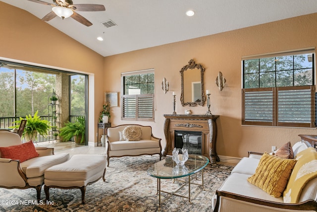 living room featuring ceiling fan and lofted ceiling