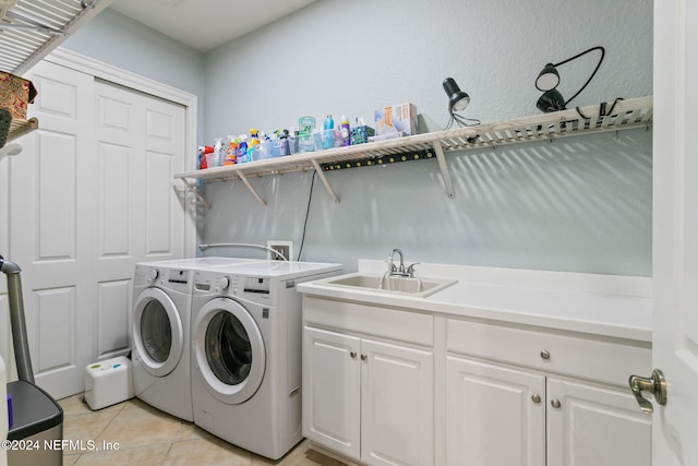 laundry area with light tile patterned flooring, cabinets, sink, and separate washer and dryer