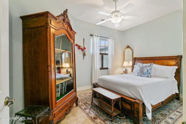 bedroom featuring light tile patterned flooring and ceiling fan