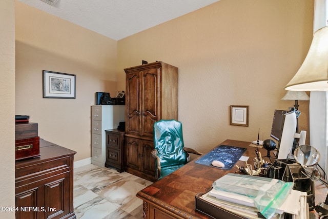 home office featuring a textured ceiling