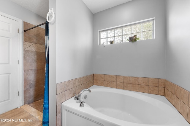 bathroom with separate shower and tub