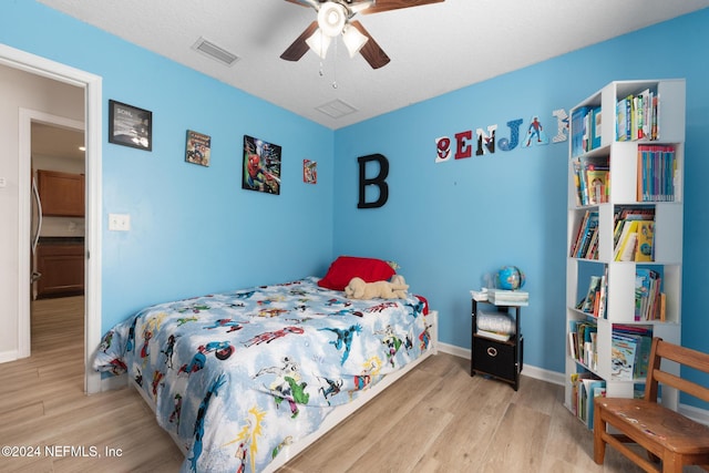 bedroom featuring light wood-type flooring and ceiling fan