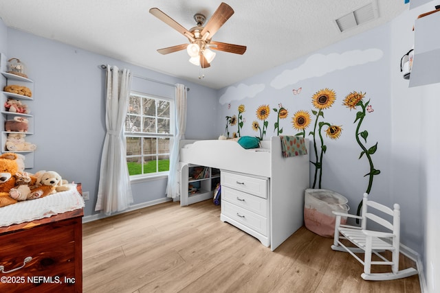 bedroom featuring ceiling fan and light wood-type flooring