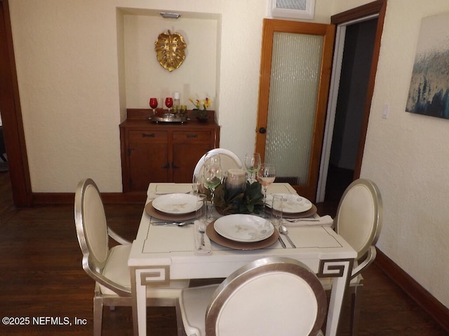 dining area with wood finished floors, visible vents, and baseboards