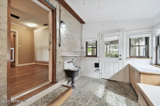 full bathroom with ornamental molding, a freestanding tub, visible vents, and wood finished floors