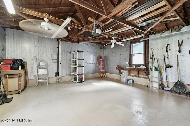 garage with a workshop area and a garage door opener