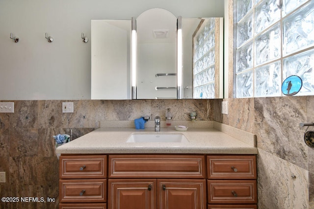 bathroom with tile walls and vanity