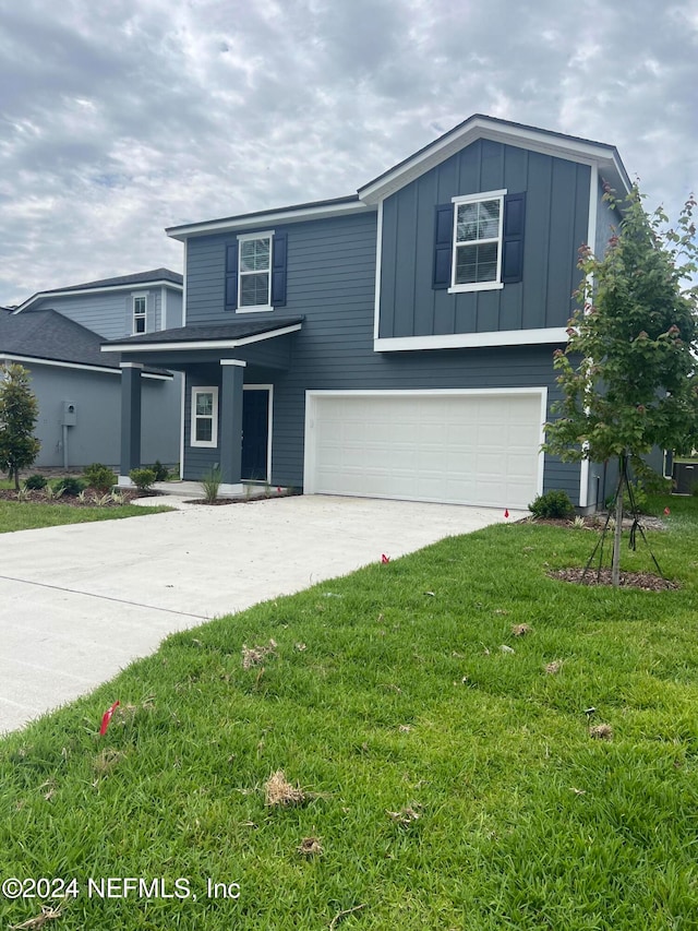 view of front of property featuring a garage and a front yard